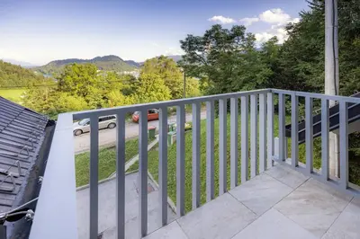 a balcony of a house with a car on the road at Luxury Apartment Stilla in Bled