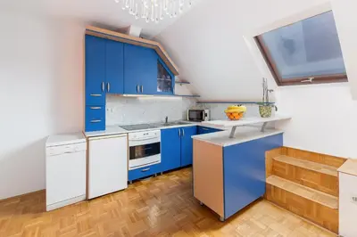 a kitchen with blue cabinets and white appliances at Apartma Lea in Slovenj Gradec