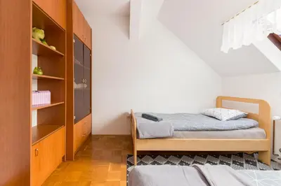 a bedroom with a bed and a book shelf at Apartma Lea in Slovenj Gradec