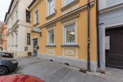 a yellow building on the side of a street at Apartma Lea in Slovenj Gradec