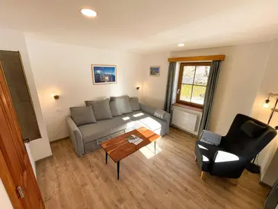 a living room with a couch and a table at Apartment House Prezlc in Kranjska Gora