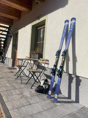 two blue skis are leaning against a building at Apartment House Prezlc in Kranjska Gora