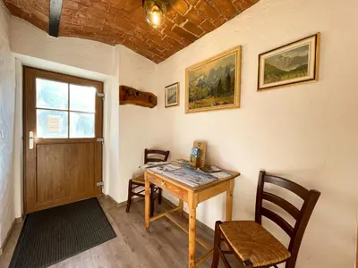 a room with a table and chairs and a door at Apartment House Prezlc in Kranjska Gora