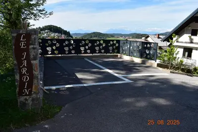 a parking lot with a gate with a sign at apartmaji LEJARDIN in Škofljica