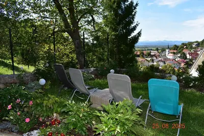 a group of chairs sitting in the grass at apartmaji LEJARDIN in Škofljica
