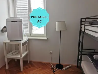 a room with a computer on a table next to a bed at Apartment for four with free parking in Ljubljana