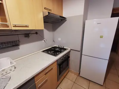 a kitchen with a white refrigerator and a stove at Apartment for four with free parking in Ljubljana