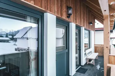 a sliding glass door on a house with a porch at Podlipnik Apartments in Kranjska Gora