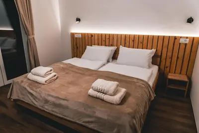 a bedroom with a bed with two towels on it at Podlipnik Apartments in Kranjska Gora