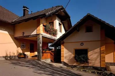 a building with flowers on the side of it at Houses and Apt in Smarjeske Toplice Kranjska Krain 26042 in Smarjeske Toplice