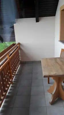 an empty sanctuary with a wooden table and benches at Houses and Apt in Smarjeske Toplice Kranjska Krain 26042 in Smarjeske Toplice