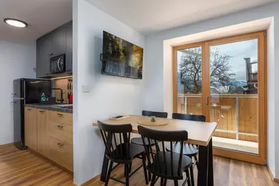 a kitchen and dining room with a table and chairs at House Godec - Rateče Planica in Kranjska Gora