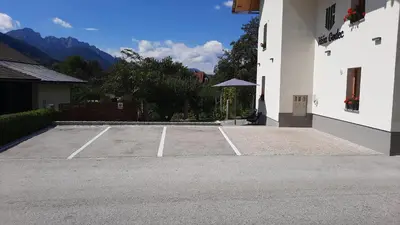 a tennis court in front of a building at House Godec - Rateče Planica in Kranjska Gora