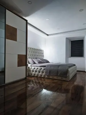 a bedroom with a large bed and a large mirror at Stara Pošta Apartment 8 in Grosuplje