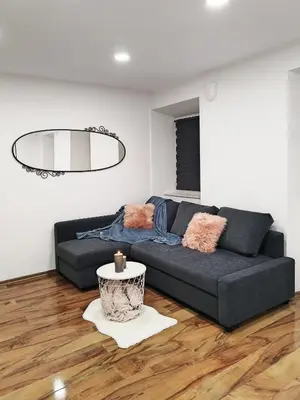 a living room with a couch and a table at Stara Pošta Apartment 8 in Grosuplje