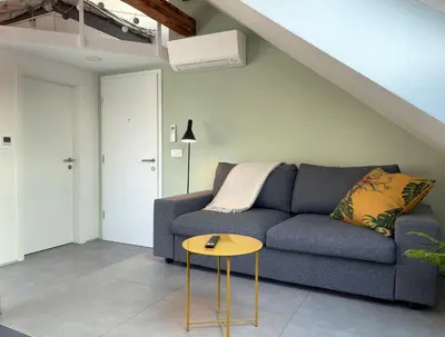 a living room with a blue couch and a table at Relax & Enjoy Ljubljana in Ljubljana