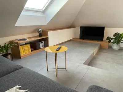 a living room with a couch and a television at Relax & Enjoy Ljubljana in Ljubljana