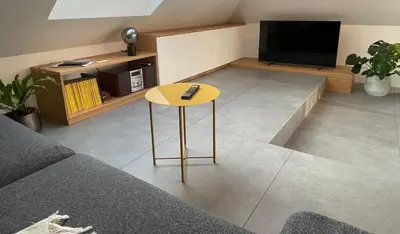 a living room with a table and a television at Relax & Enjoy Ljubljana in Ljubljana
