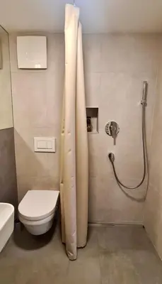 a bathroom with a shower with a toilet and a sink at Relax & Enjoy Ljubljana in Ljubljana