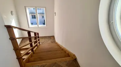 a staircase in a room with a window at Relax & Enjoy Ljubljana in Ljubljana