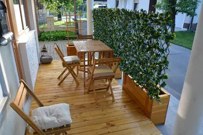 a patio with a table and chairs and a plant at Apartment Ljubljana Marsh Nature Park in Brest