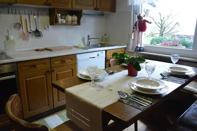 a kitchen with a table with plates and glasses on it at Apartment Ljubljana Marsh Nature Park in Brest