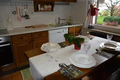 a kitchen with a table with plates and glasses on it at Apartment Ljubljana Marsh Nature Park in Brest