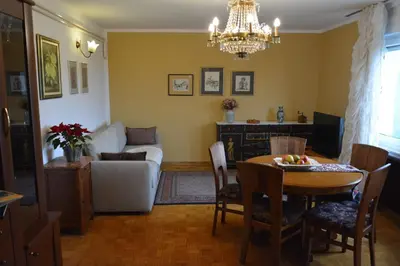 a living room with a table and a couch at Apartment Ljubljana Marsh Nature Park in Brest