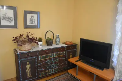 a living room with a television and a dresser at Apartment Ljubljana Marsh Nature Park in Brest