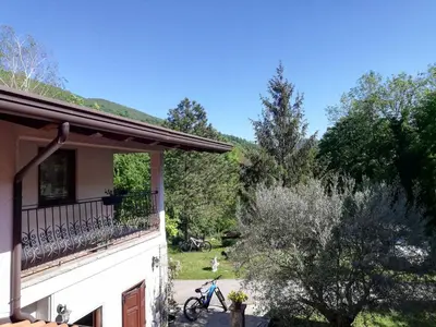 a bike parked on a balcony of a house at Pri Martinovih in Deskle