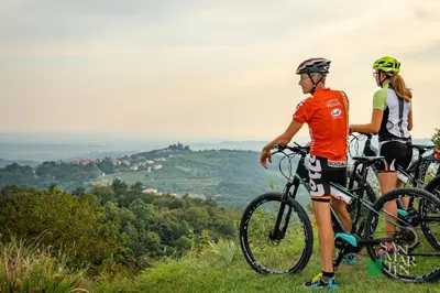 two people standing on a hill with their bikes at Pri Martinovih in Deskle