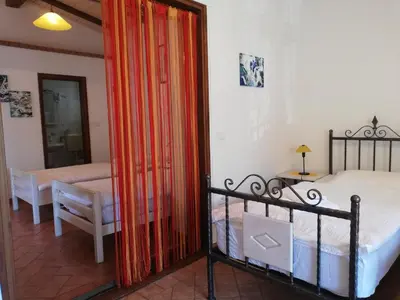 a bedroom with a bed and a mirror in a room at Pri Martinovih in Deskle