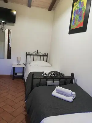 a room with two beds in a room at Pri Martinovih in Deskle