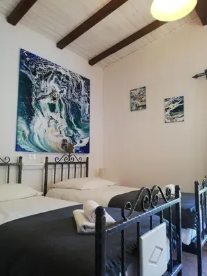 a room with two beds and a painting on the wall at Pri Martinovih in Deskle
