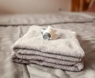 a pile of towels sitting on top of a bed at APARTMA JEREBIKA ŠT. 20 in Pohorje