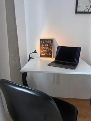 a laptop computer sitting on a desk with a chair at APARTMA JEREBIKA ŠT. 20 in Pohorje