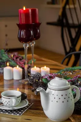 a table with a tea pot and candles on it at Apartments Gozdni Raj Rogla in Oplotnica
