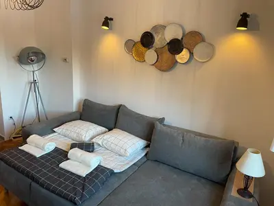 a living room with a couch and some baskets at Apartments Gozdni Raj Rogla in Oplotnica