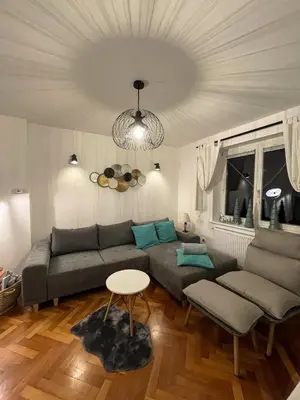 a living room with a couch and a table at Apartments Gozdni Raj Rogla in Oplotnica