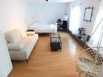 a living room with a couch and a bed at Old Town Theatre Staircase Apartments in Ljubljana