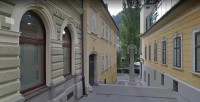 an alley in an old town with yellow buildings at Old Town Theatre Staircase Apartments in Ljubljana