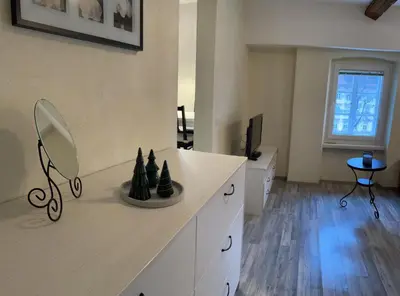 a room with a counter with a mirror and a tv at Old Town Theatre Staircase Apartments in Ljubljana