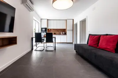 a living room with a couch and a table at Apartments Ursus in Bled
