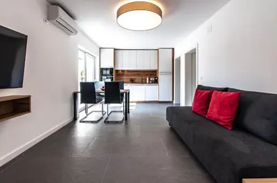 a living room with a couch and a table at Apartments Ursus in Bled