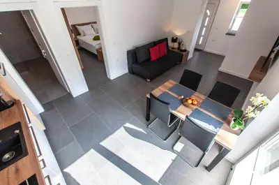 an overhead view of a living room with a table and chairs at Apartments Ursus in Bled