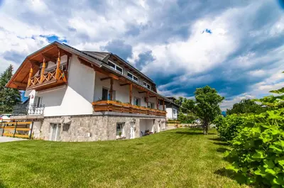 a house with a large yard in front of it at Apartments Ursus in Bled