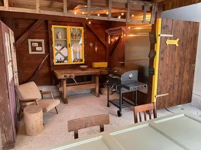 a room with a table and a grill in a cabin at House Pucnk-beautiful countryside in Železniki