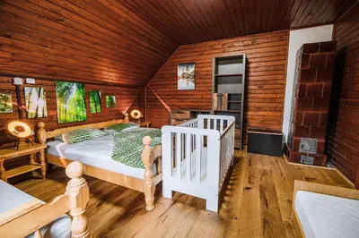 a bedroom with a bed in a wooden cabin at Holiday Home Iris in Zgornje Jezersko