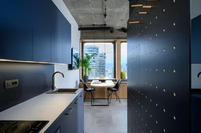 a kitchen with blue walls and a table with chairs at Delo 2.0. in Ljubljana