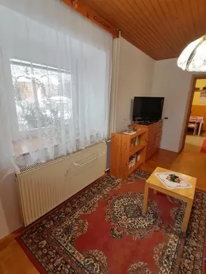 a living room with a large window and a television at Apartma Tilika in Kranjska Gora